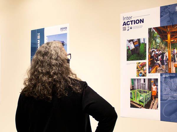 woman looking at a poster on the wall