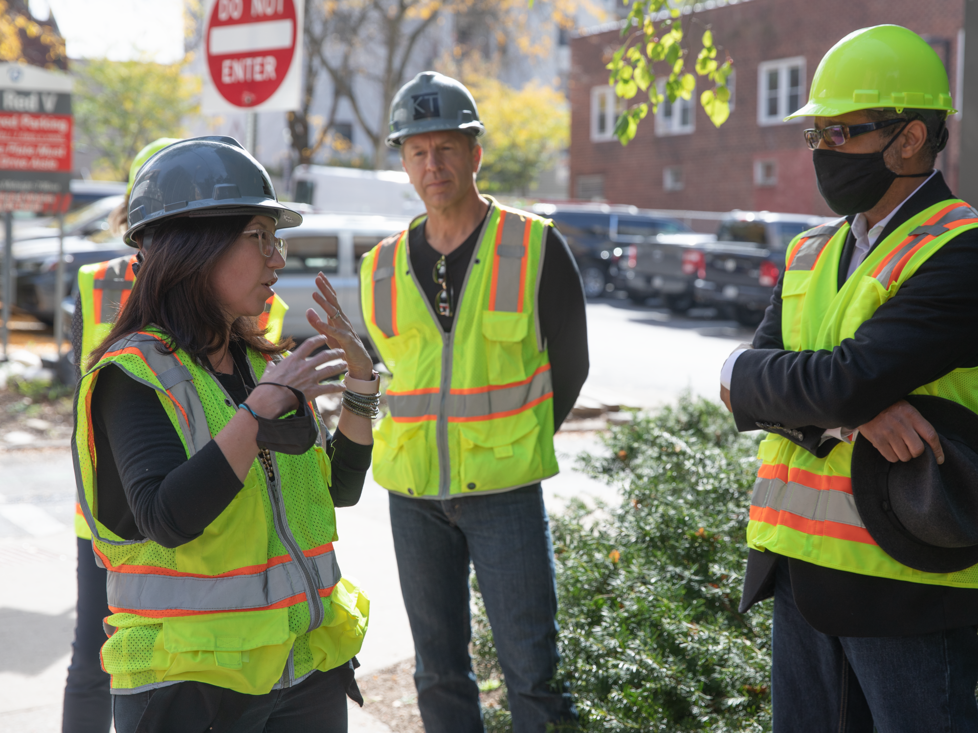 Marilia Rodrigues,Jason E. Smith and Dean Carpenter pictured in hardhats and safety vests.