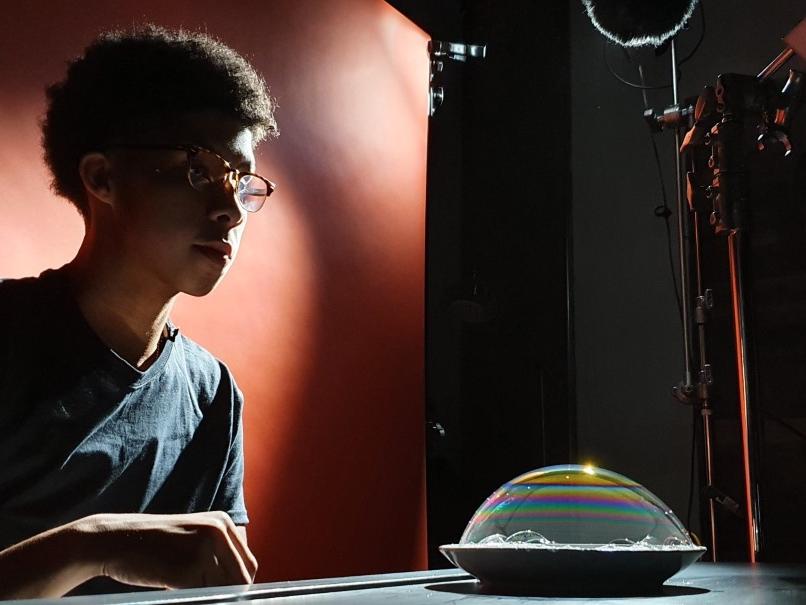Young man in studio filming video
