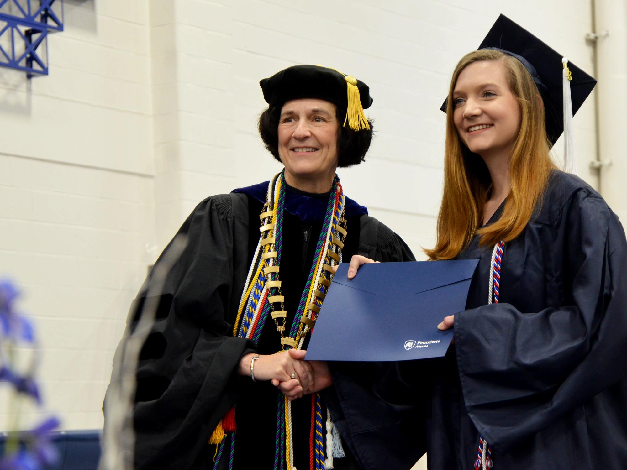 Lori Bechtel-Wherry posing with graduate