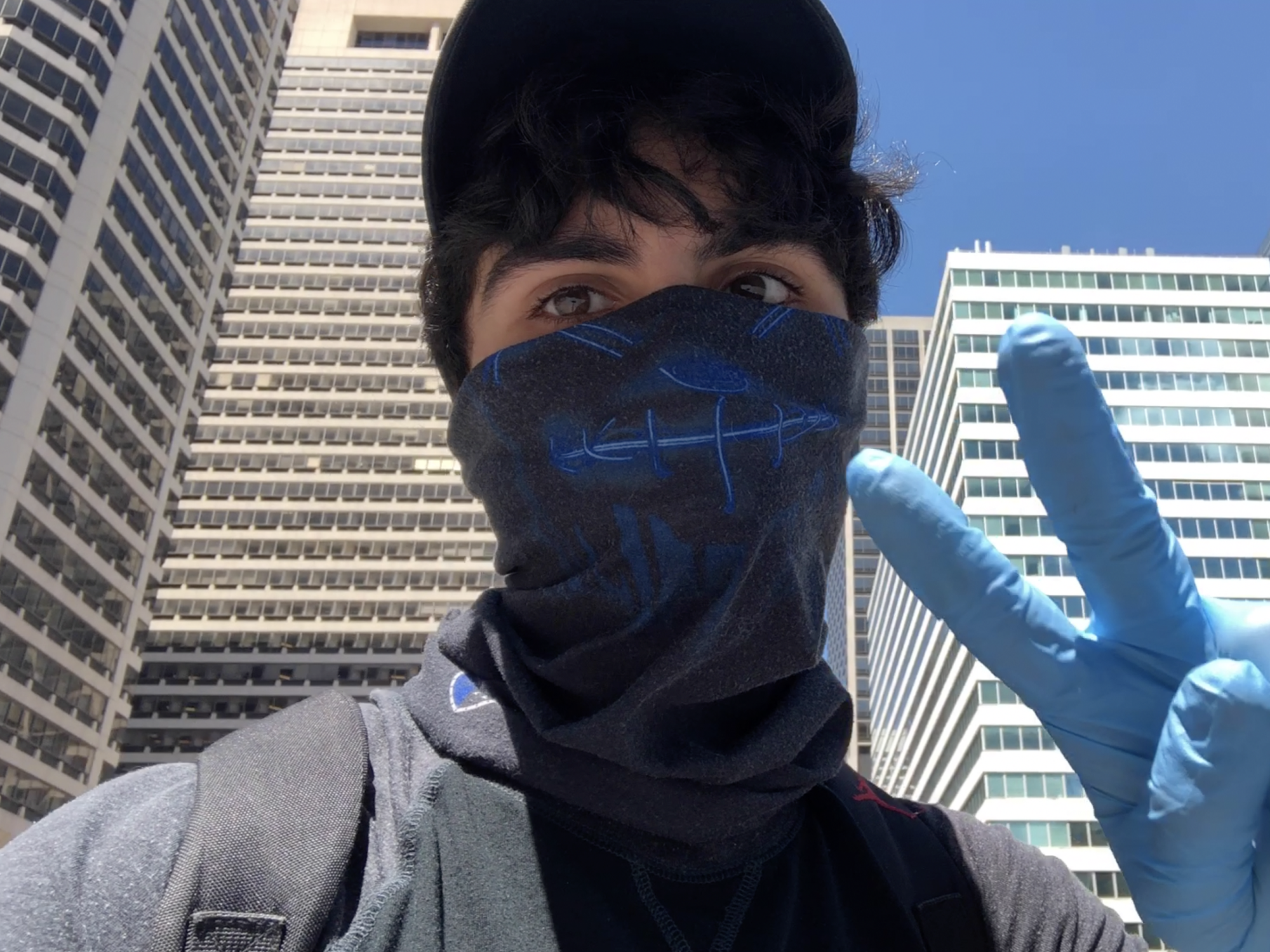 Jacob Mejias wearing a mask and gloves as he films in Philadelphia