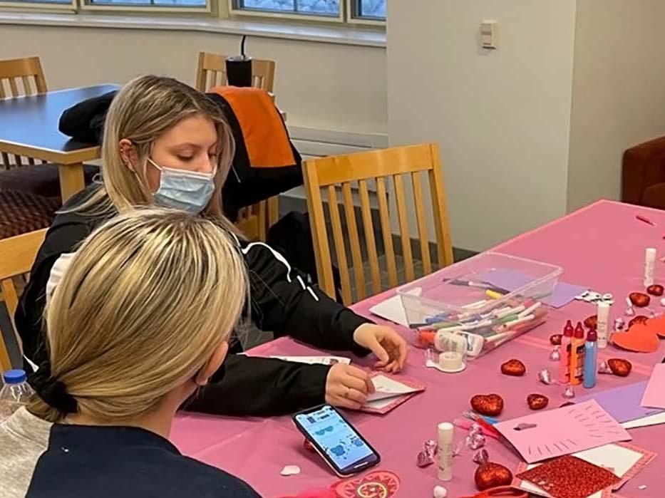 Health and Human Development students decorating Valentine's cards that will be delivered to hospice patients