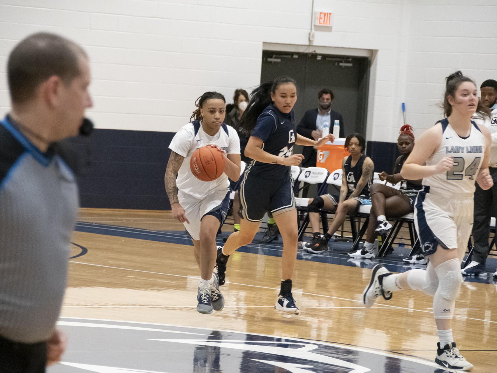 Schuylkill women's basketball players running down the court.