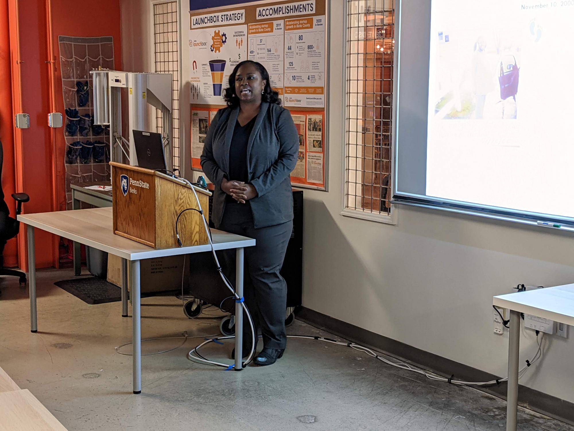 A woman presents a powerpoint to Launchbox participants