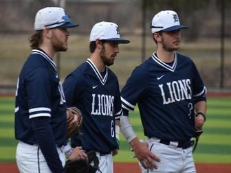 three Penn State DuBois baseball players talk at the pitching mound