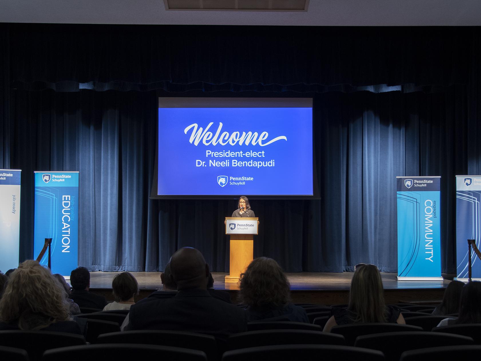 President-elect Neeli Bendapudi stands on stage at Penn State Schuylkill