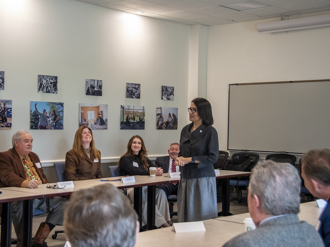 Woman speaks at the front of a meeting room