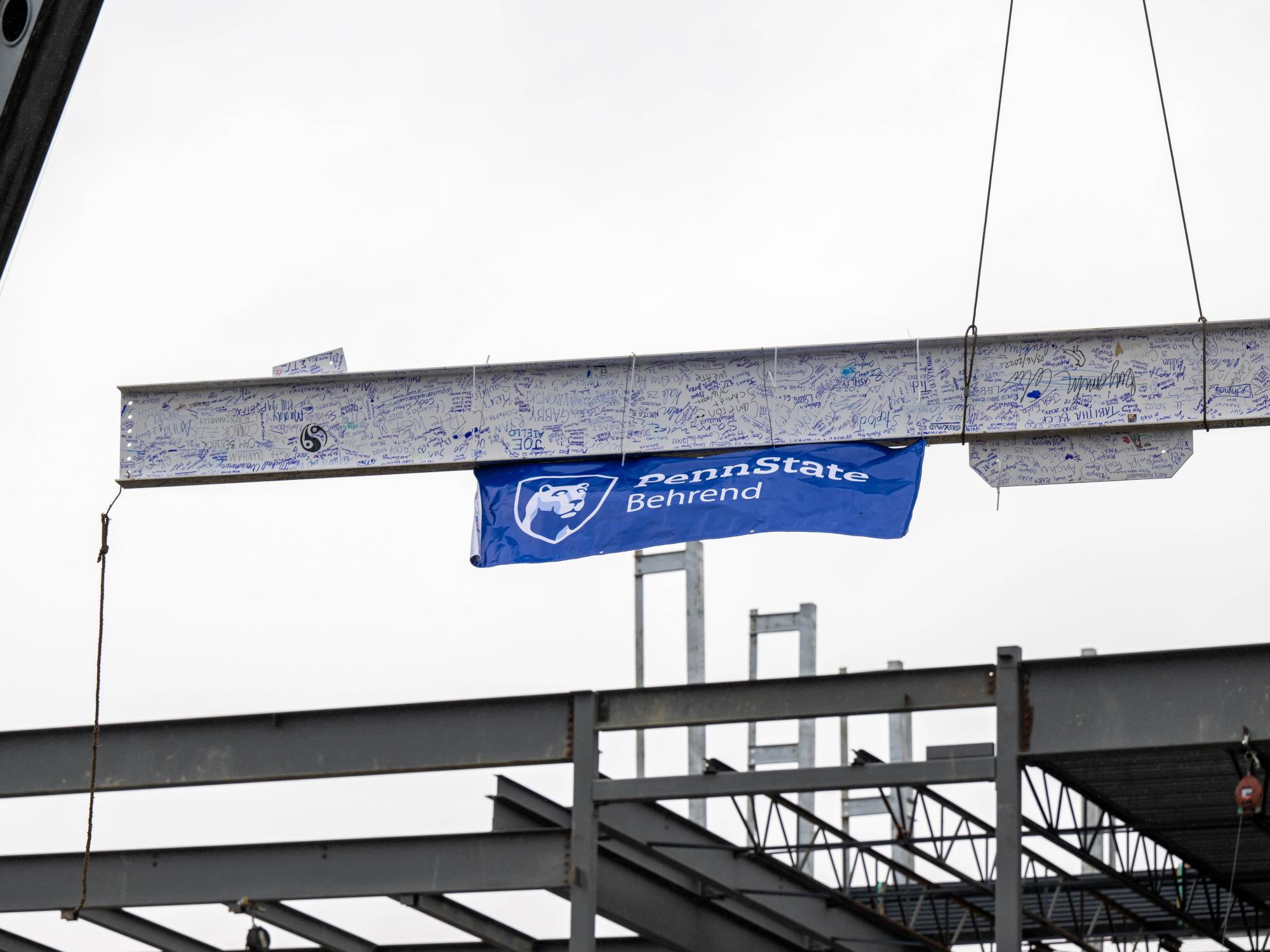 A 32-foot beam is raised at the site of Penn State Behrend's new Erie Hall.