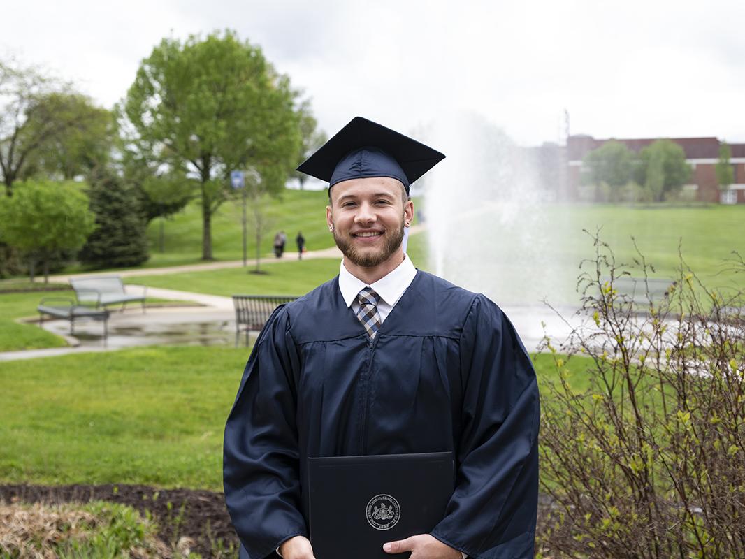 Robert Wolfson standing in front of the campus fountain.
