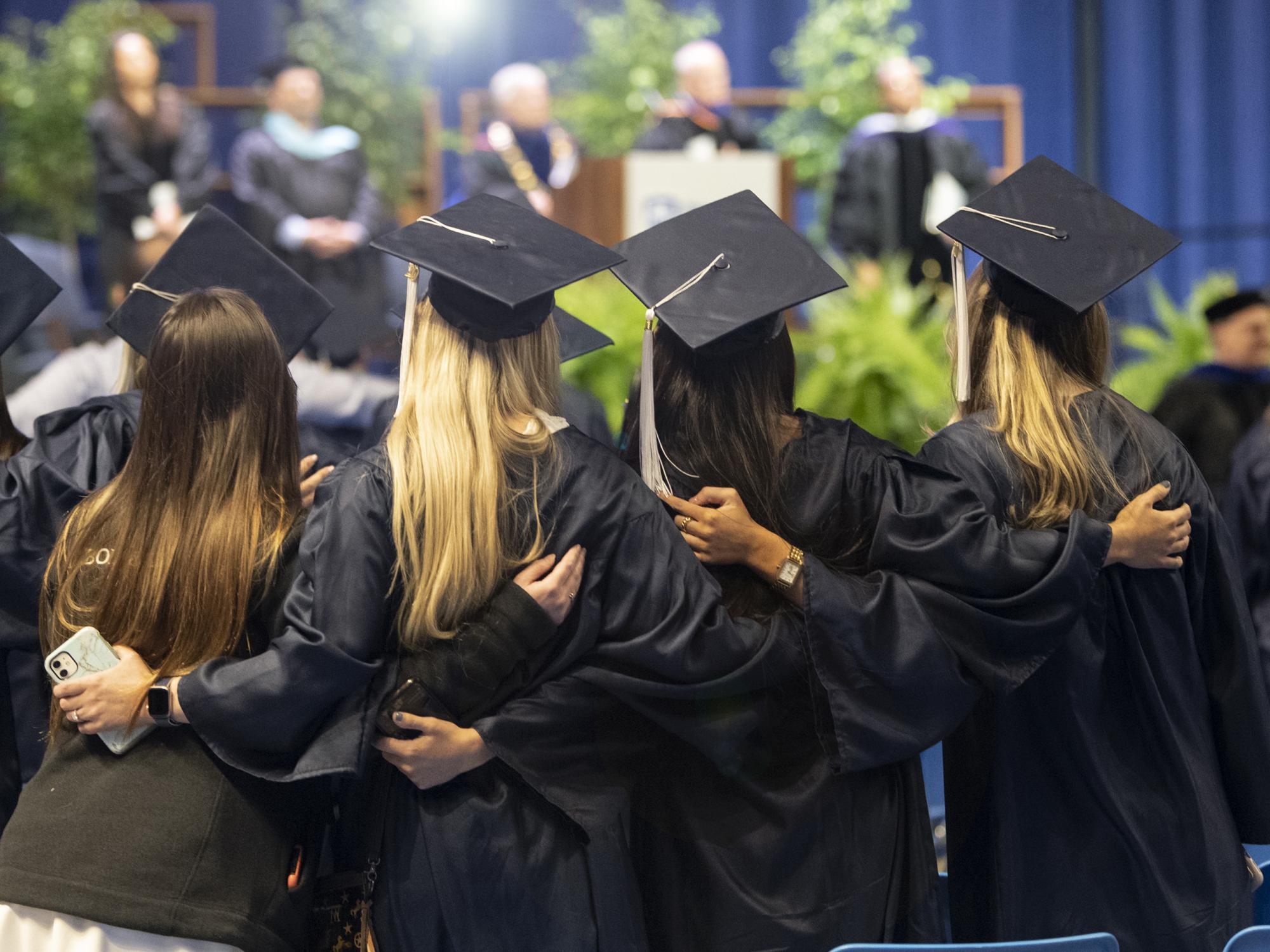 graduates sing the Alma Mater