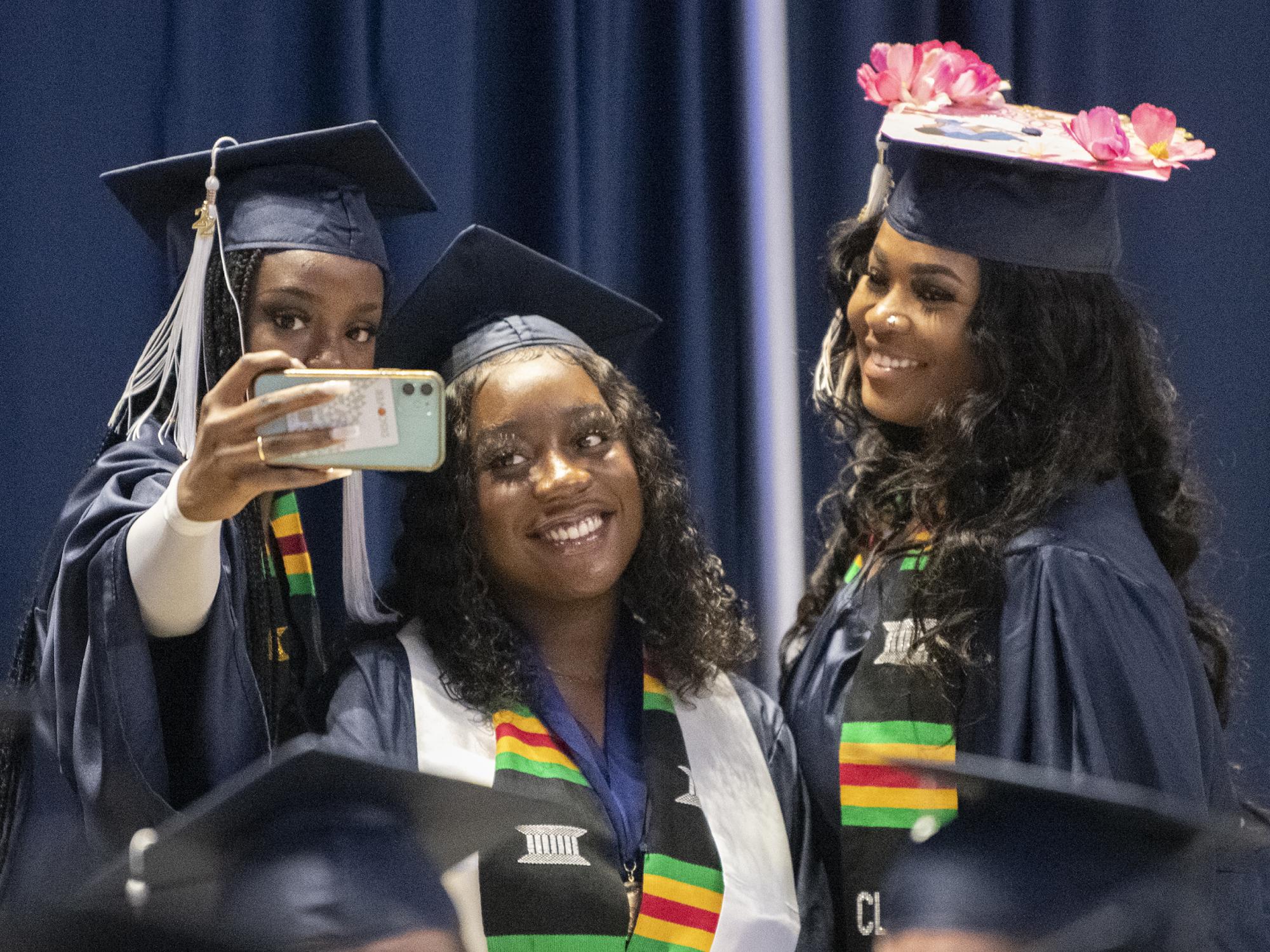 Liberal Arts grads take a selfie at graduation