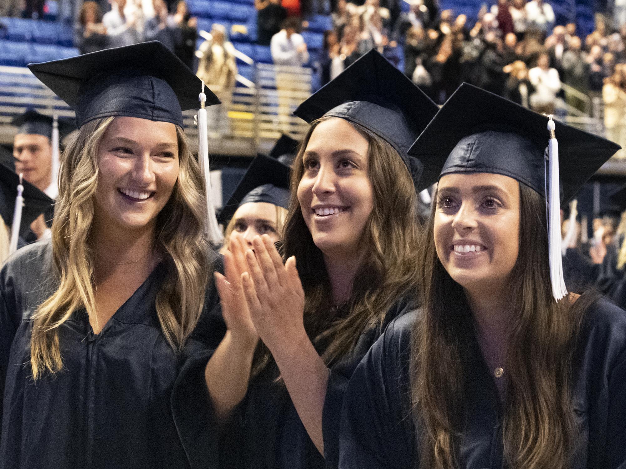 graduates applaud families