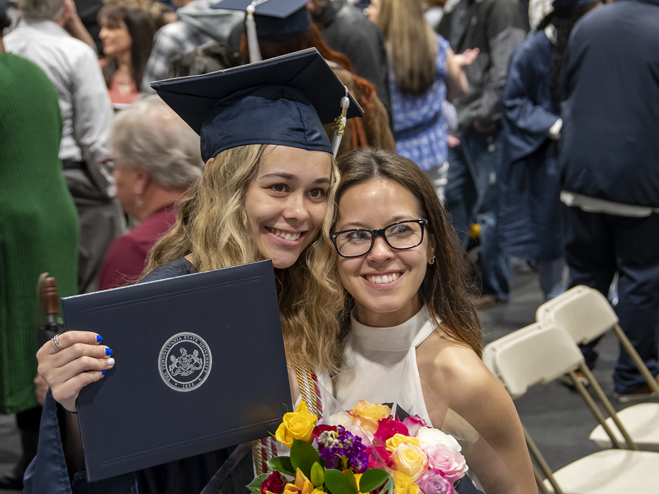 A graduate and female family member pose.
