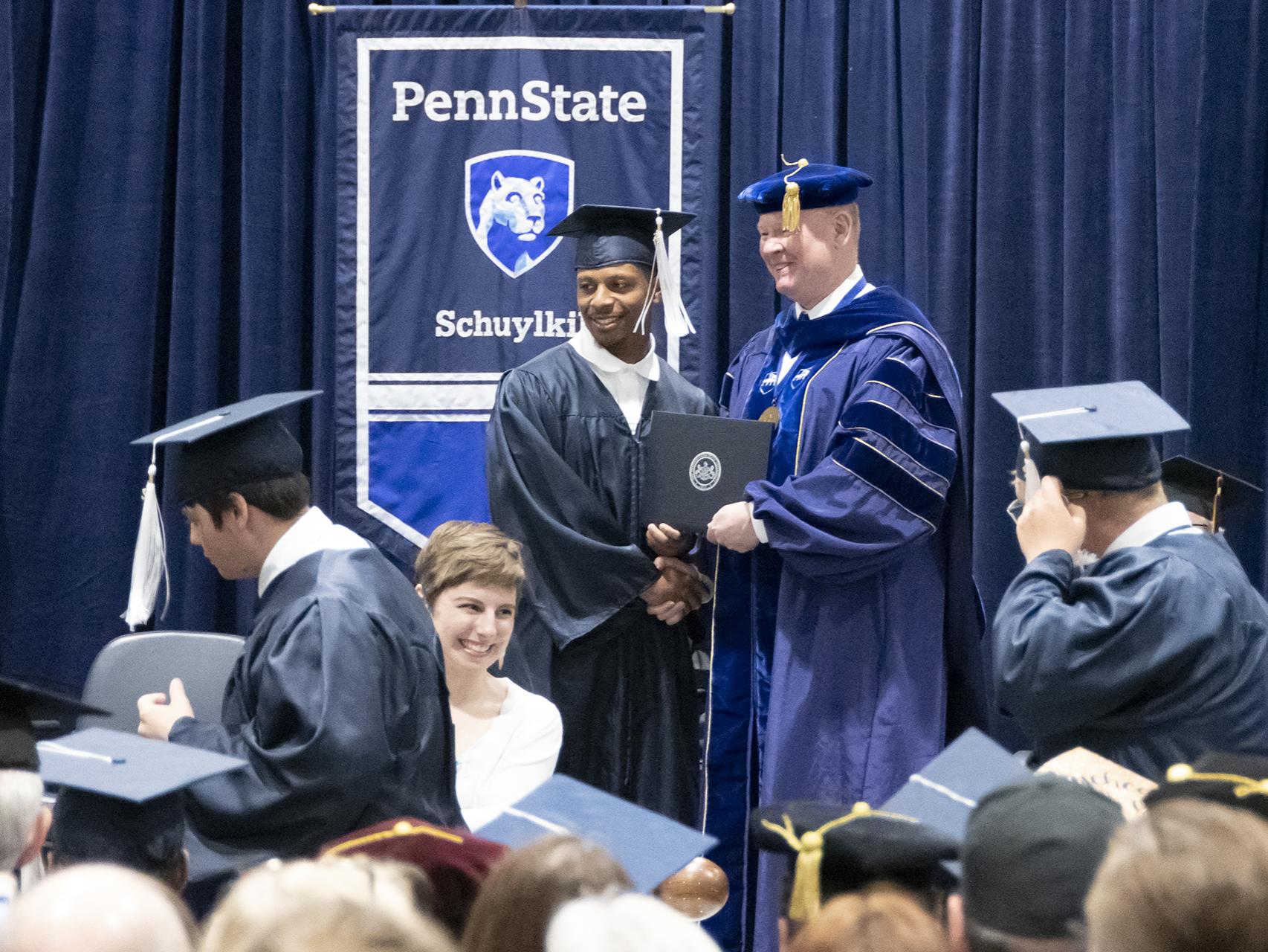Student on stage at graduation.