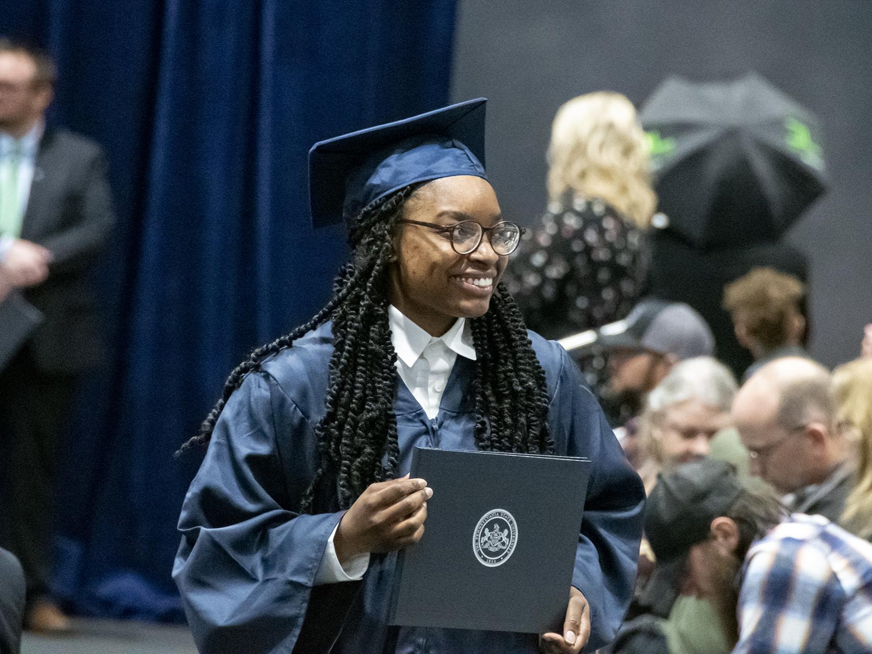 A student holds diploma.