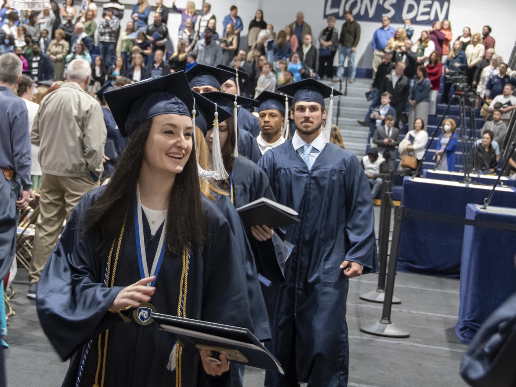 Students process at graduation.