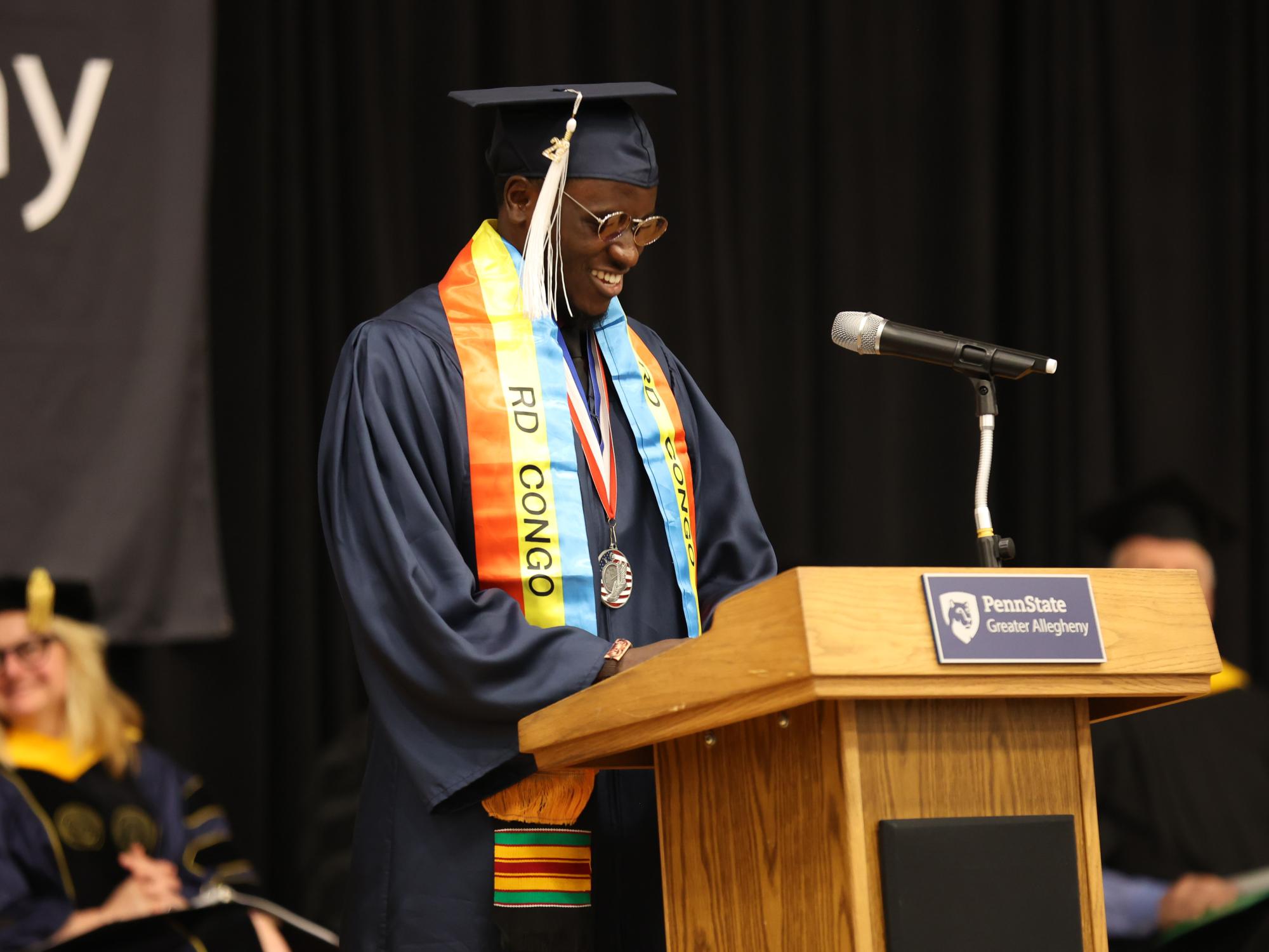 Graduate smiling at a podium