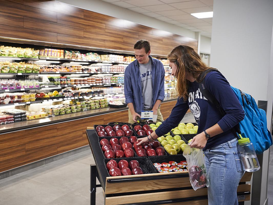 Two individuals buying food at Market East