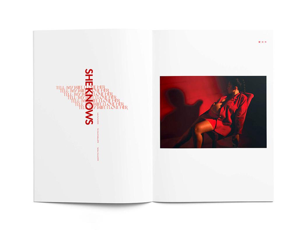 A magazine spread with the words "Tell My Wife I love Her" in red text repeated seven times down a white page in red ink at left with the words She Knows vertically down the page. At right, an image of a woman in red sitting on a chair. 