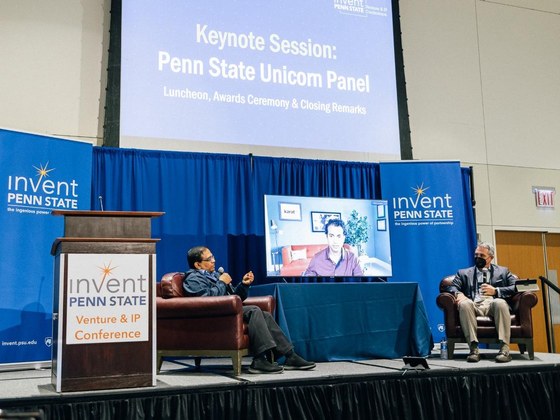 Panelists sit on stage