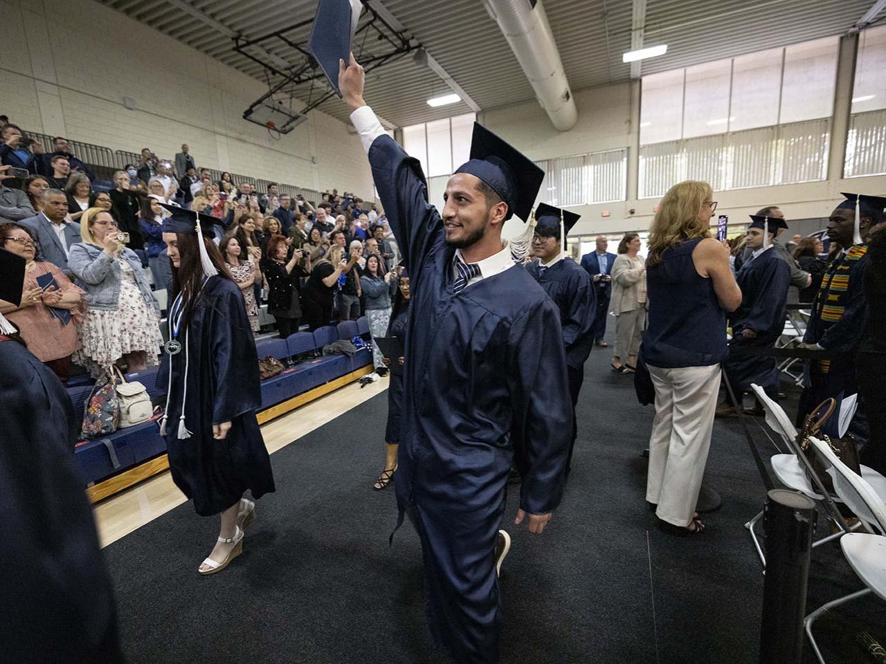 A graduate waves to the Abington Spring 2022