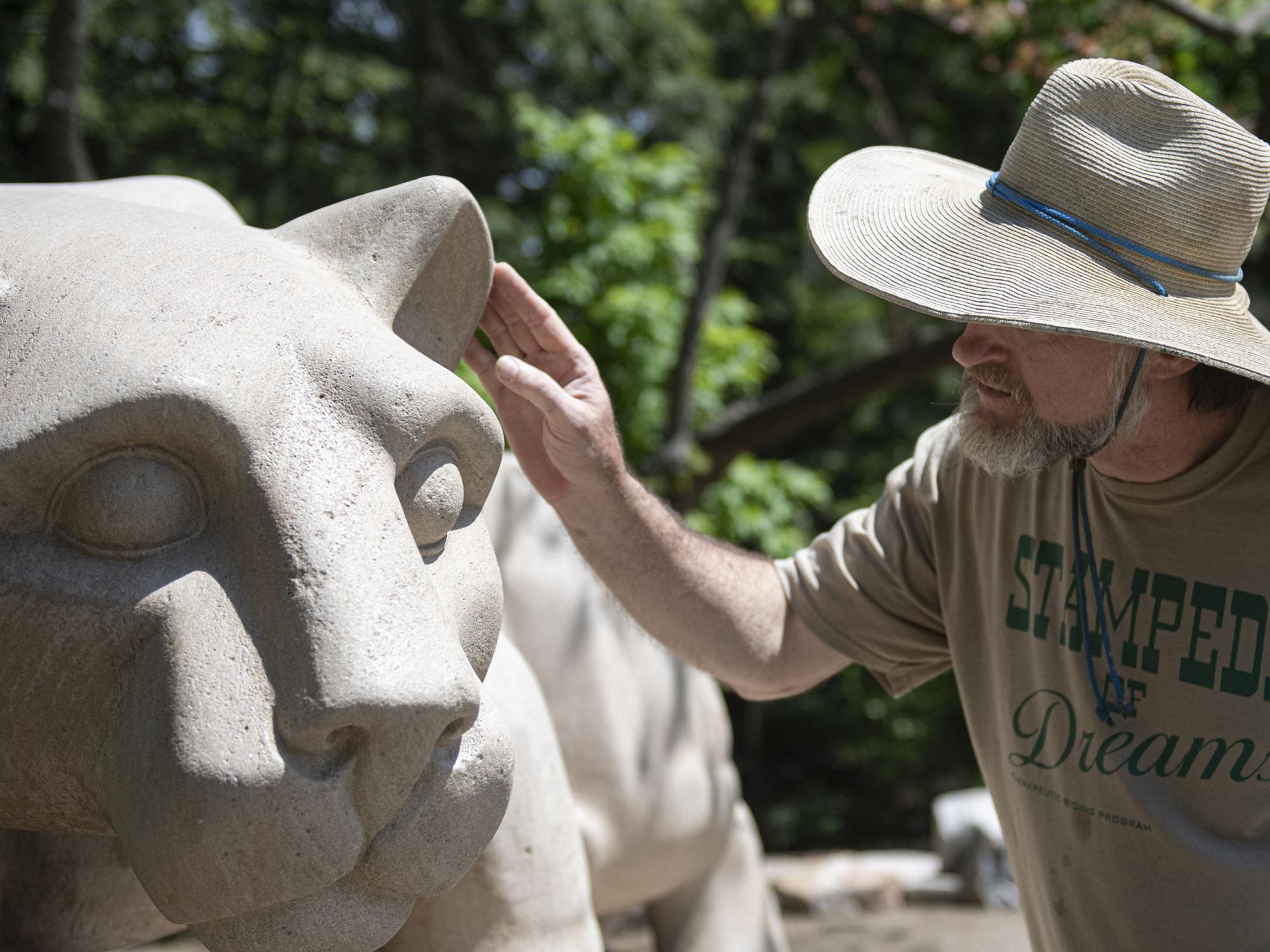 Curtis McCartney checking repairs on LIon Shrine ear