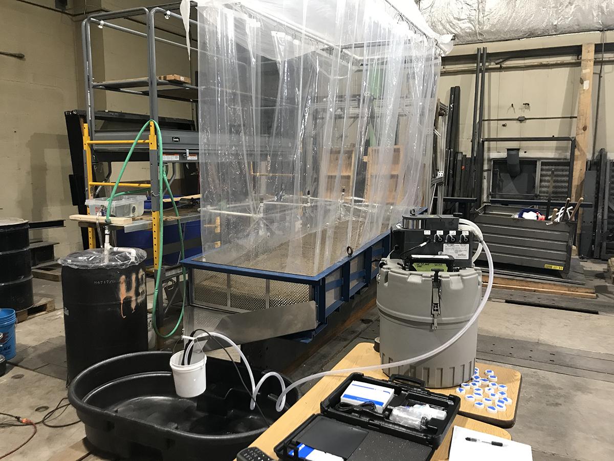 A laboratory experiment with a roadbed test frame and chute designed to capture and measure contaminants in rainfall runoff