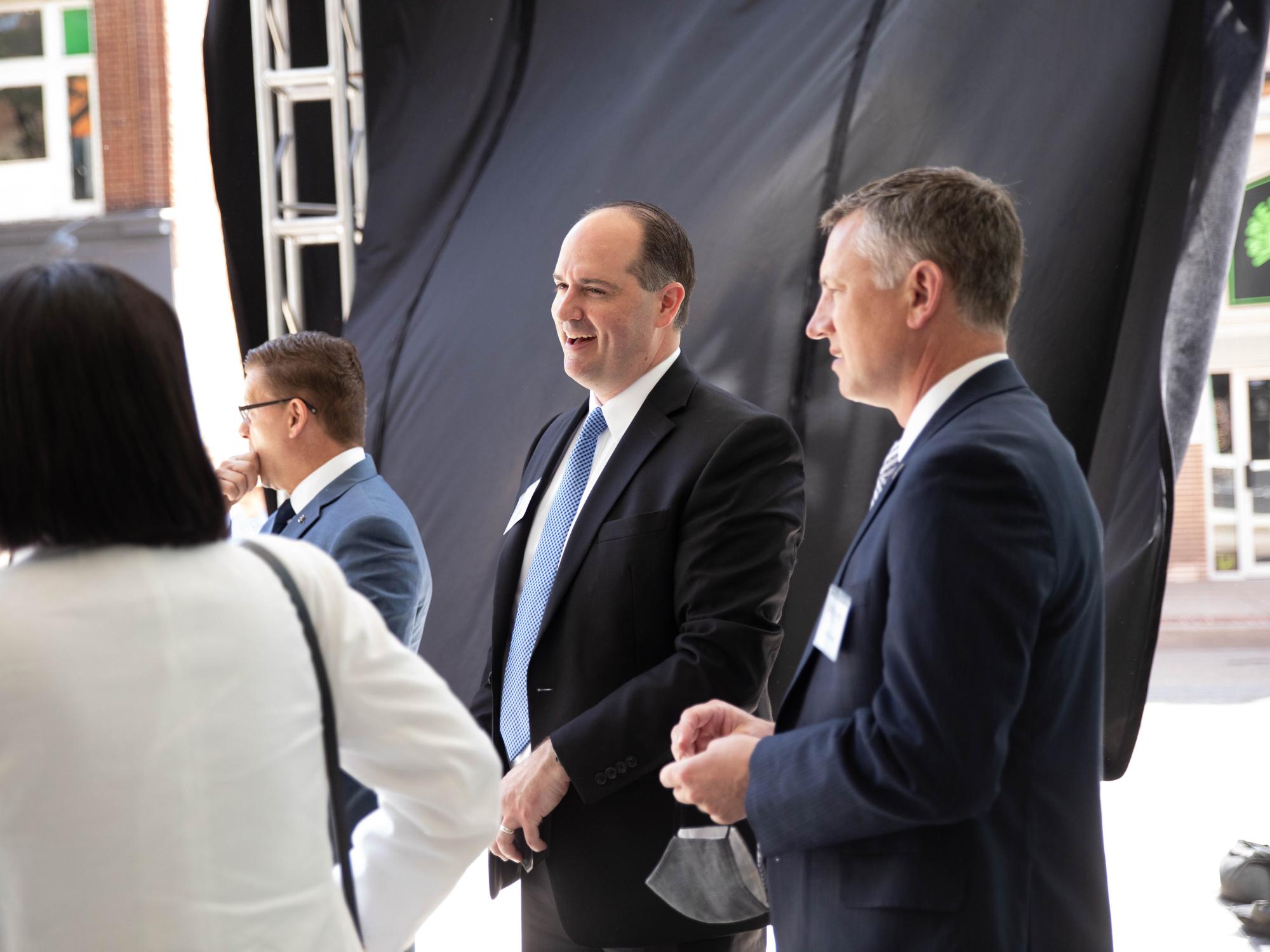 Two men stand at an event