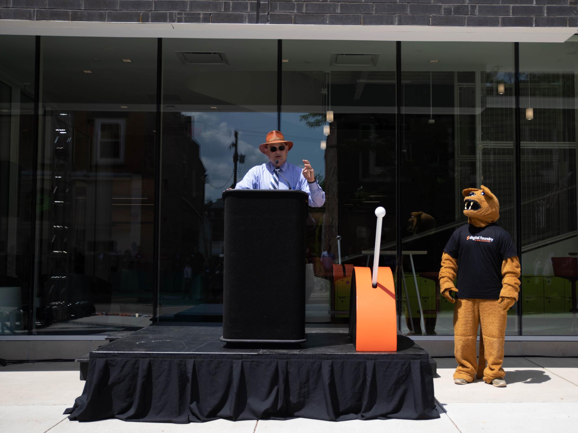 Kevin Snider stands at podium to speak