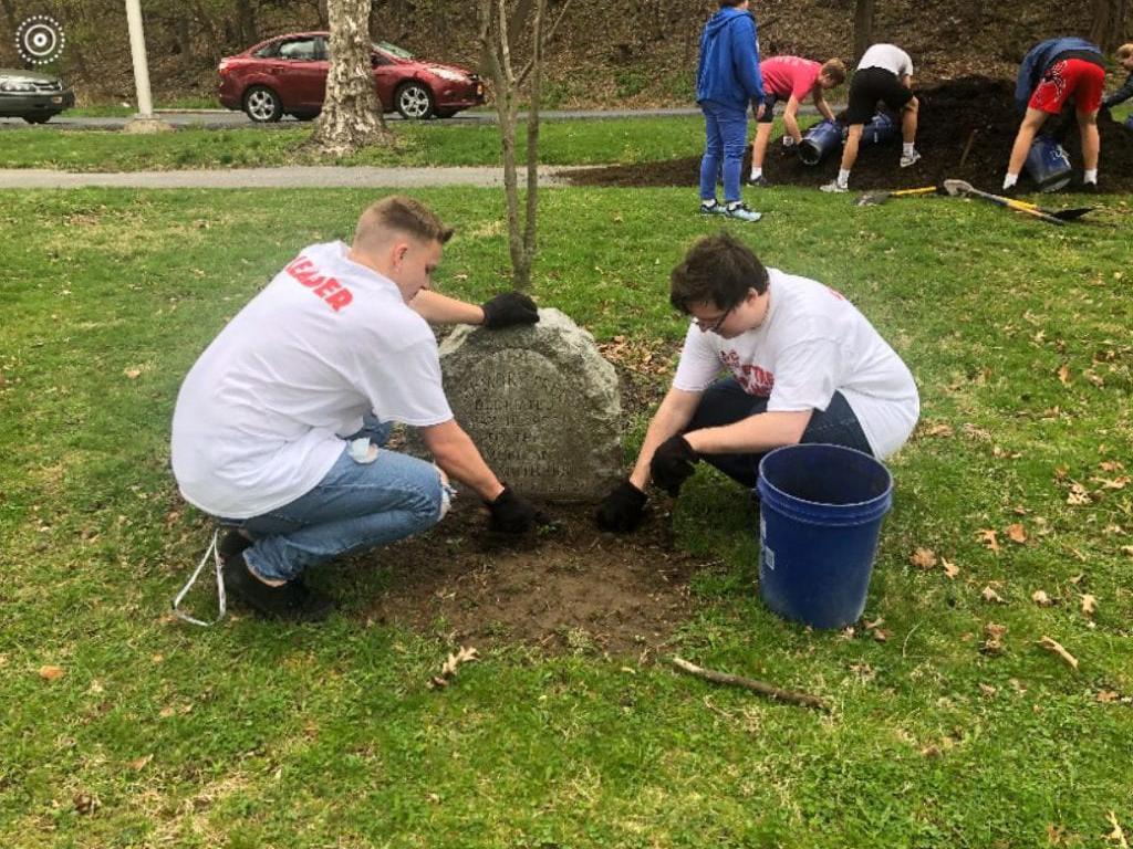 Students planting a tree.