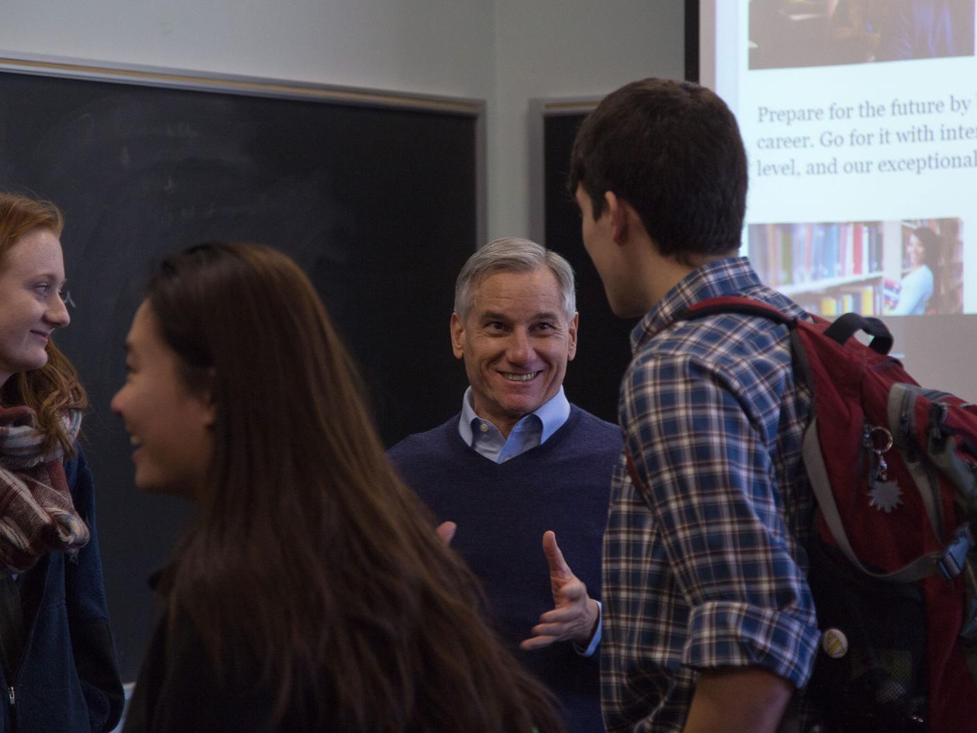 Students gather after class talking to Martarano