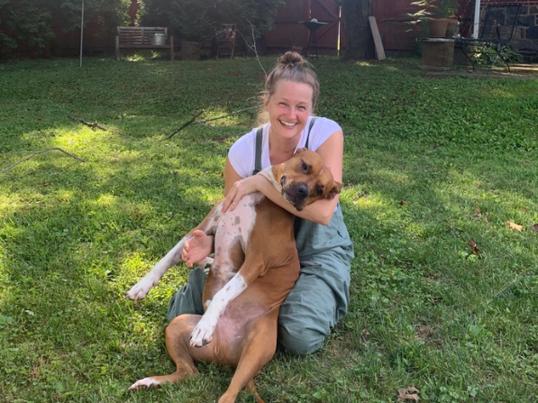 Mel McDaniel poses with her dog Marvin on the grass