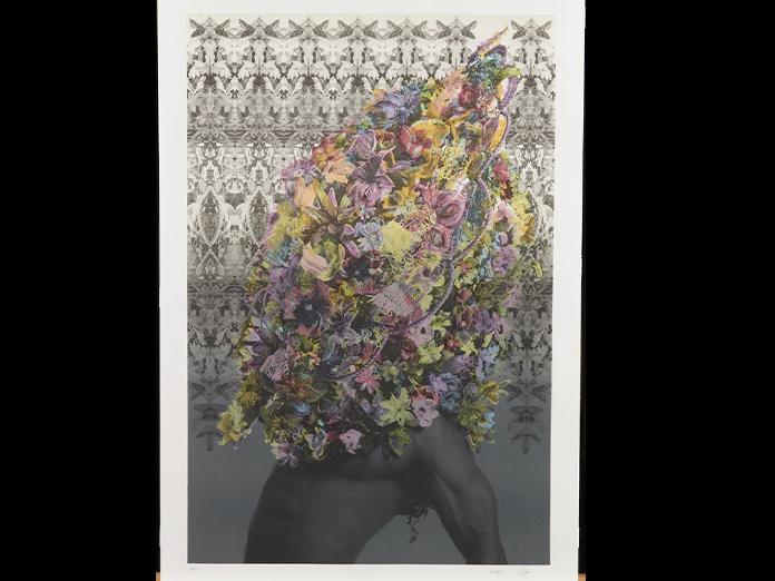 Black and white image of a male body with a colorful, floral arrangement covering his head