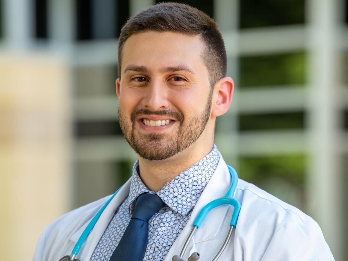 A headshot of Penn College physician assistant studies student Bryan Bilbao wearing a white coat with a stethoscope around his neck.