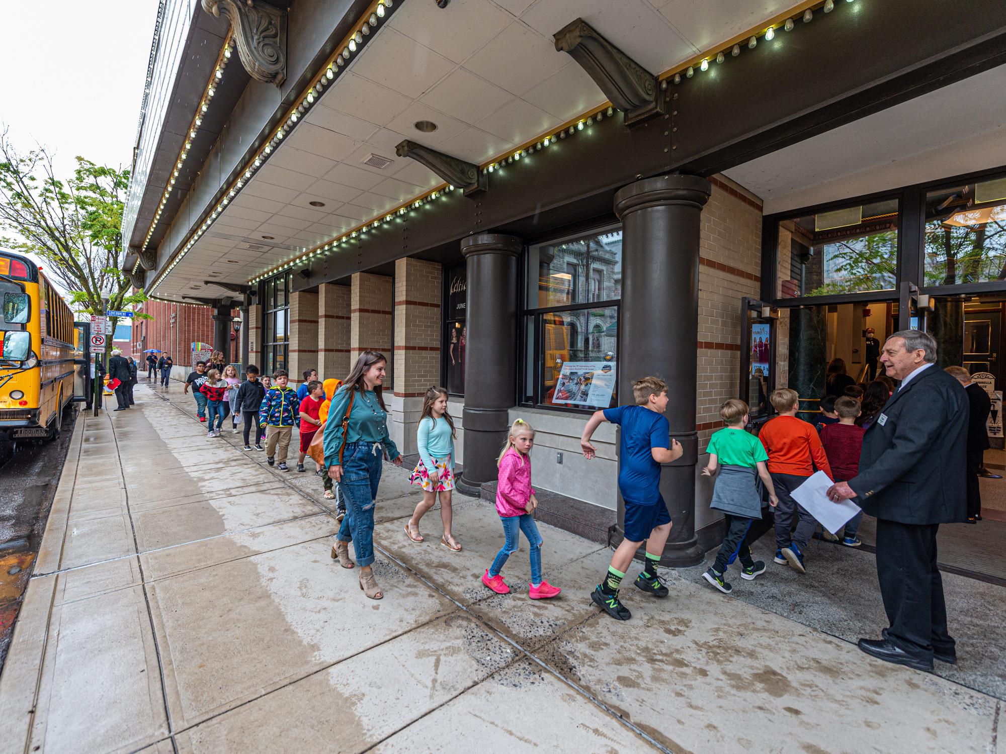 Youngsters excitedly stroll into the Community Arts Center in May for an Educational Series show. 