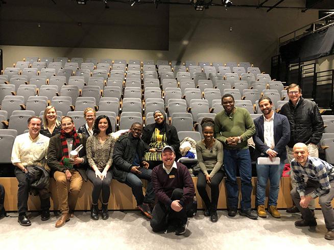 Peter Boger (center) poses with attendees at the Intersections labor film screening in the HUB theatre.