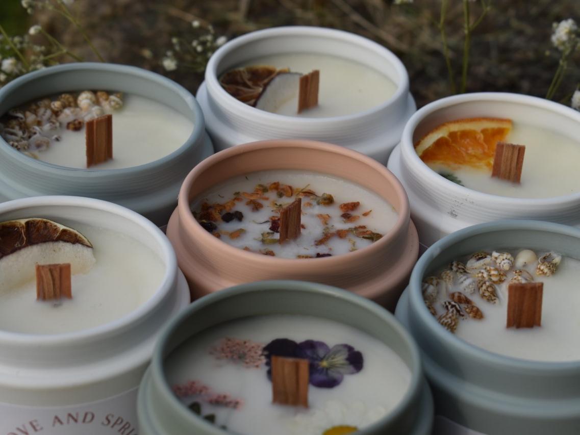 Seven of Kelsey's hand-poured soy candles are pictured