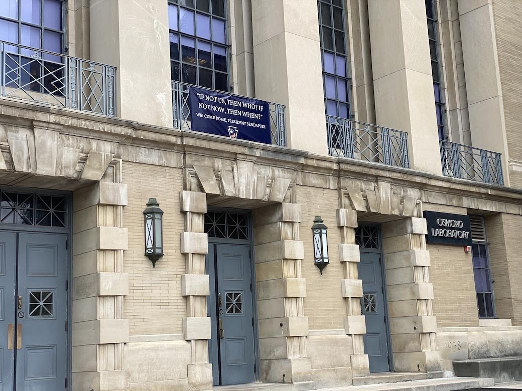 Banner hangs on outside of campus building