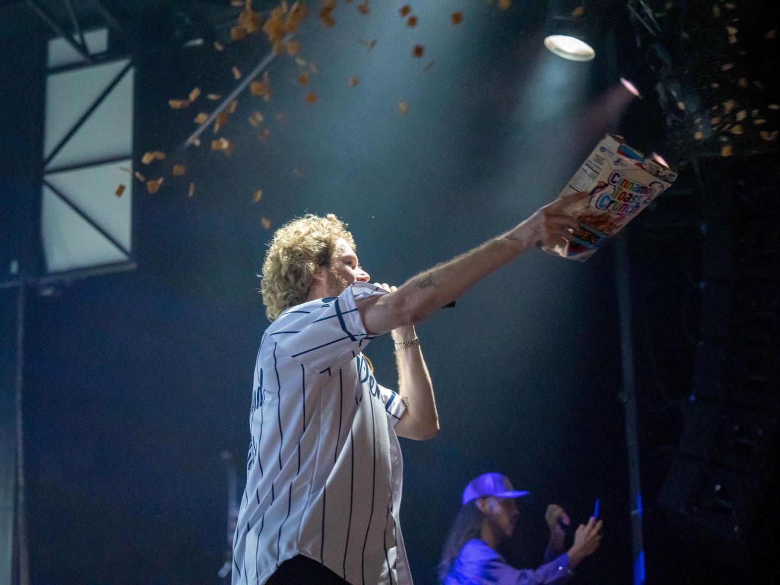 The rapper Yung Gravy throws cereal onto the crowd during the student concert at Penn State Behrend.