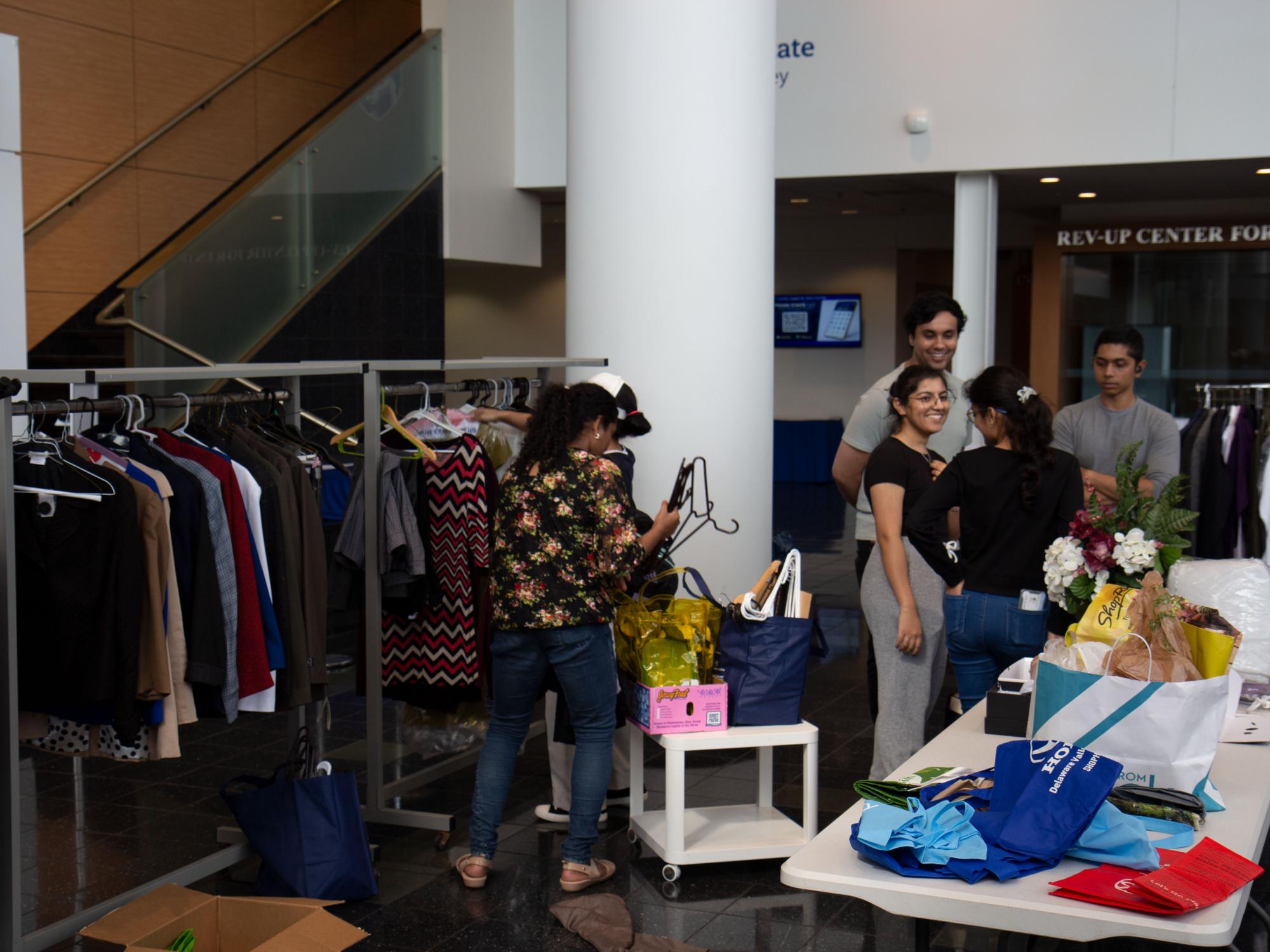 Students looking at clothes and household items in the CCB lobby
