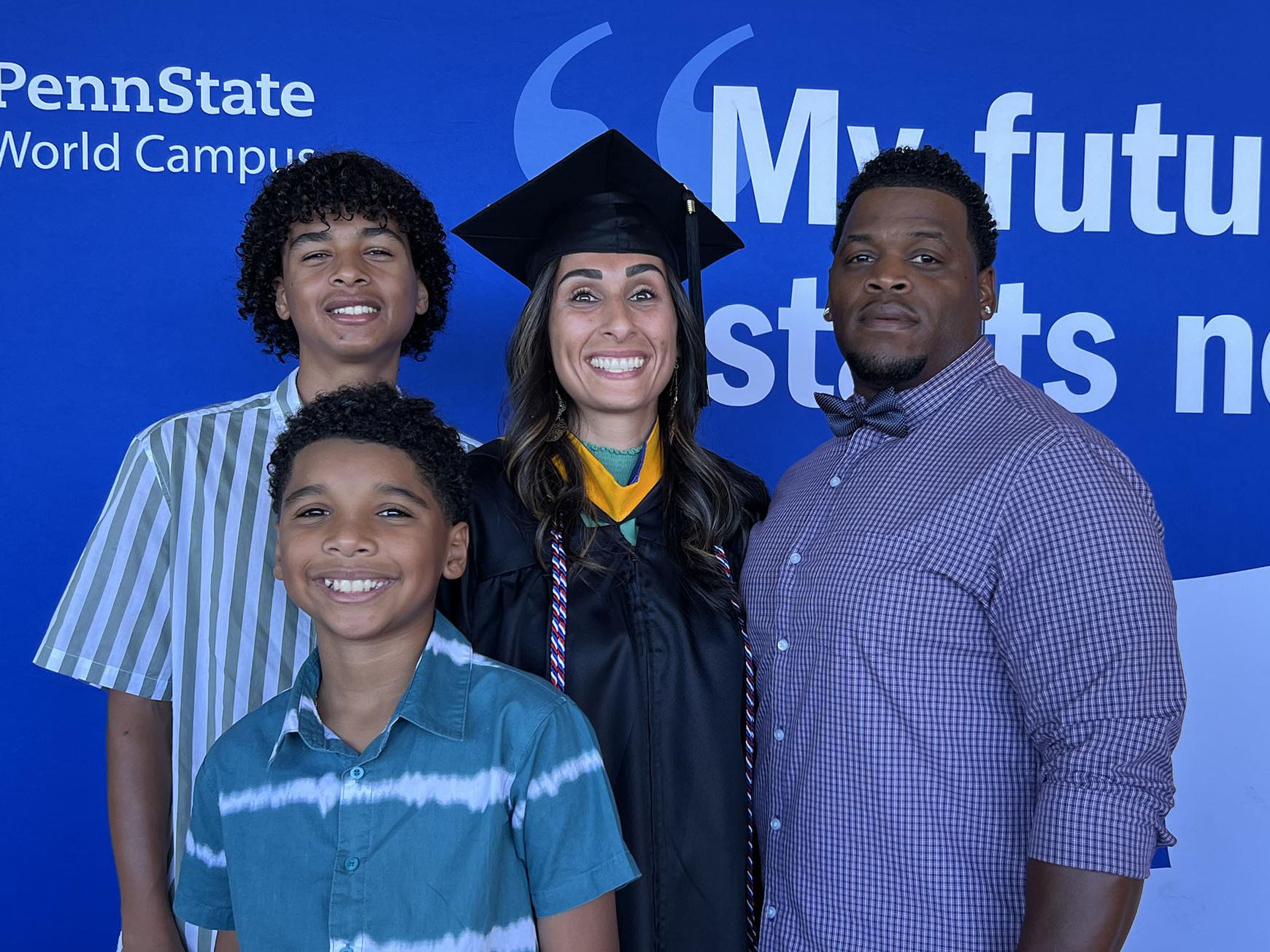 Edith Brooks stands with her family behind a banner that says "My Future Starts Now"