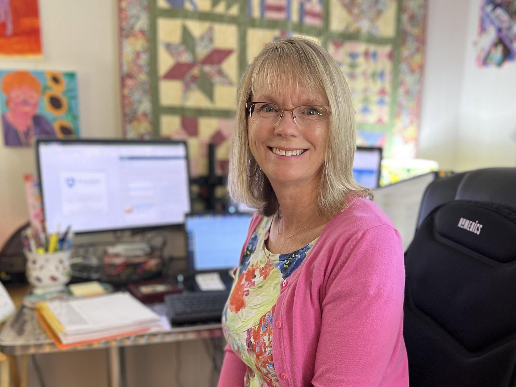 Joanne Loebig sits at her home office.