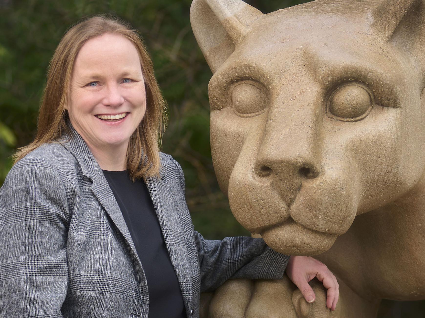 Julie Fitzgerald stands by the Nittany Lion Shrine