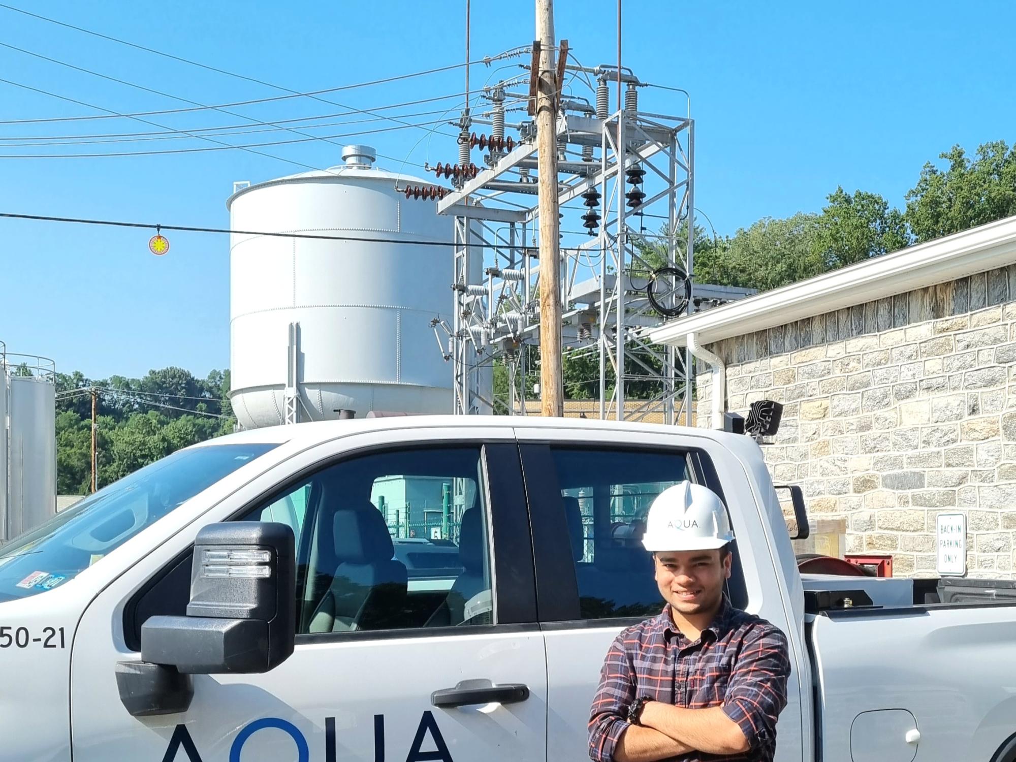Utkarsh Singh in front of an AQUA truck
