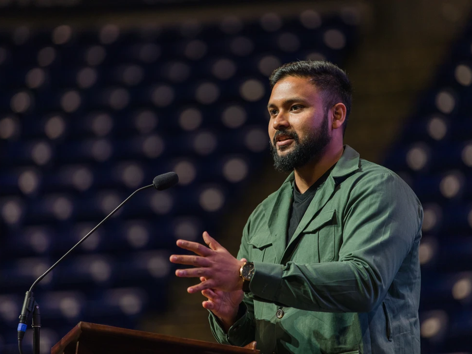 A man speaking behind a podium