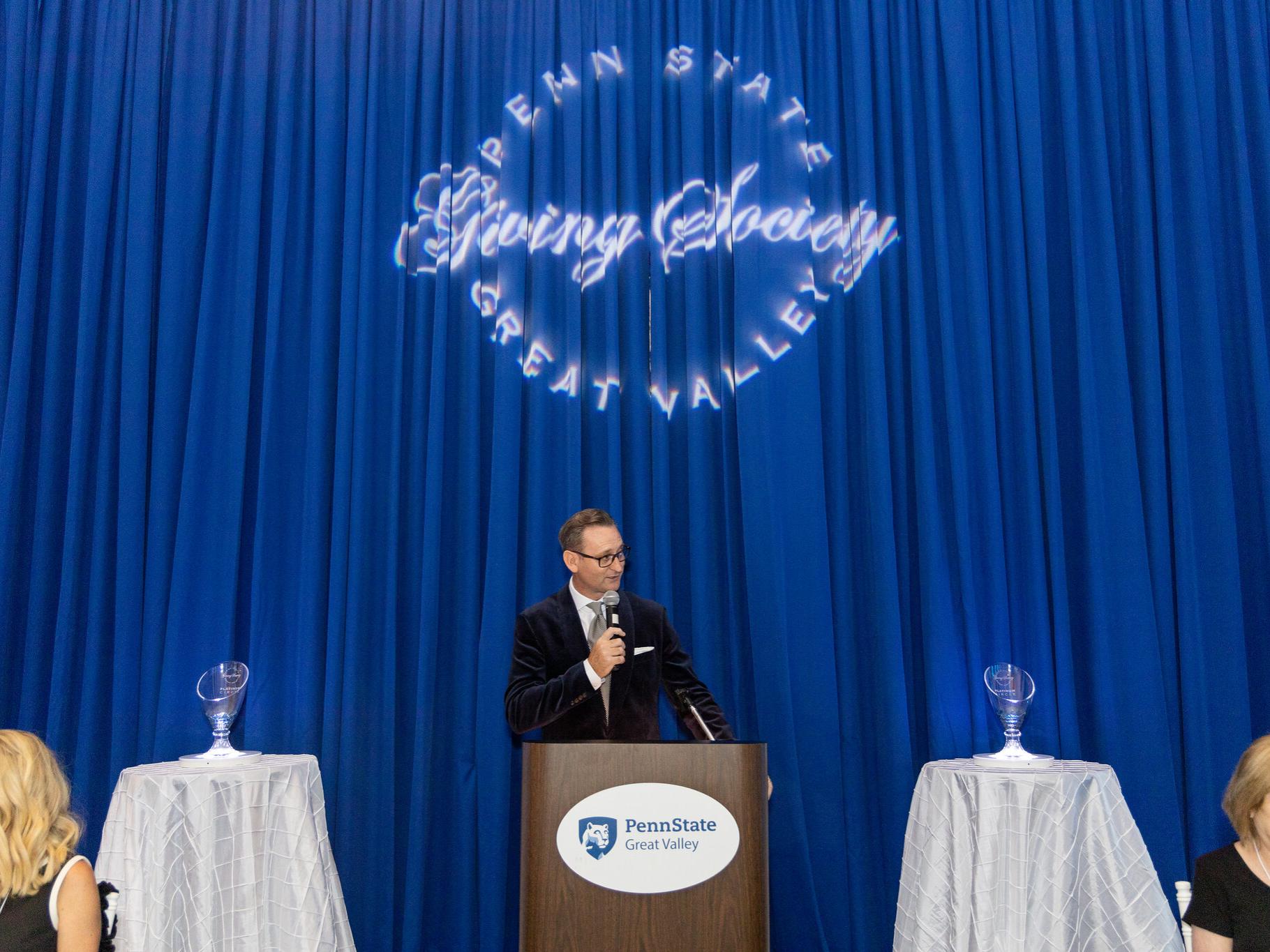 Colin Neil speaking at a podium at the Great Valley Celebrates event