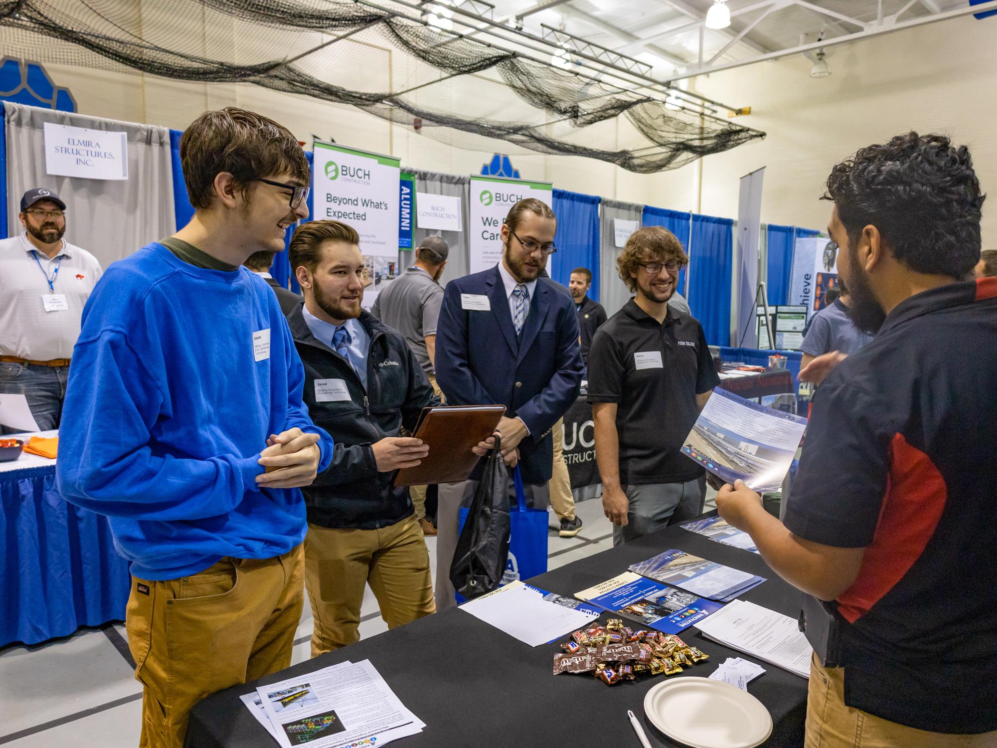 Students talk with company representatives at the career fair