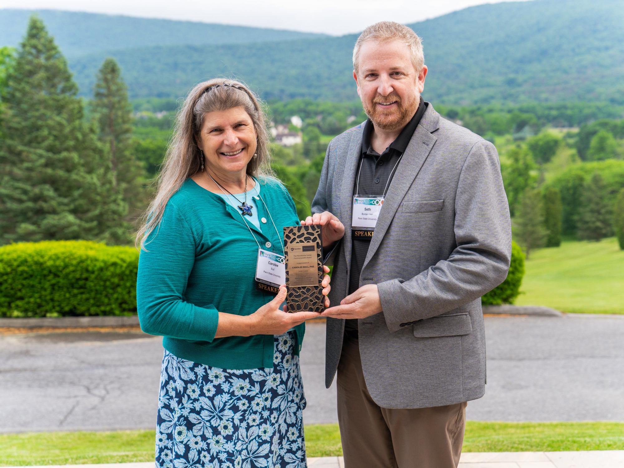 Bull receiving Inaugural Commonwealth Award from Bordenstein for commitment to and influences on the good of the microbiome sciences and community. 