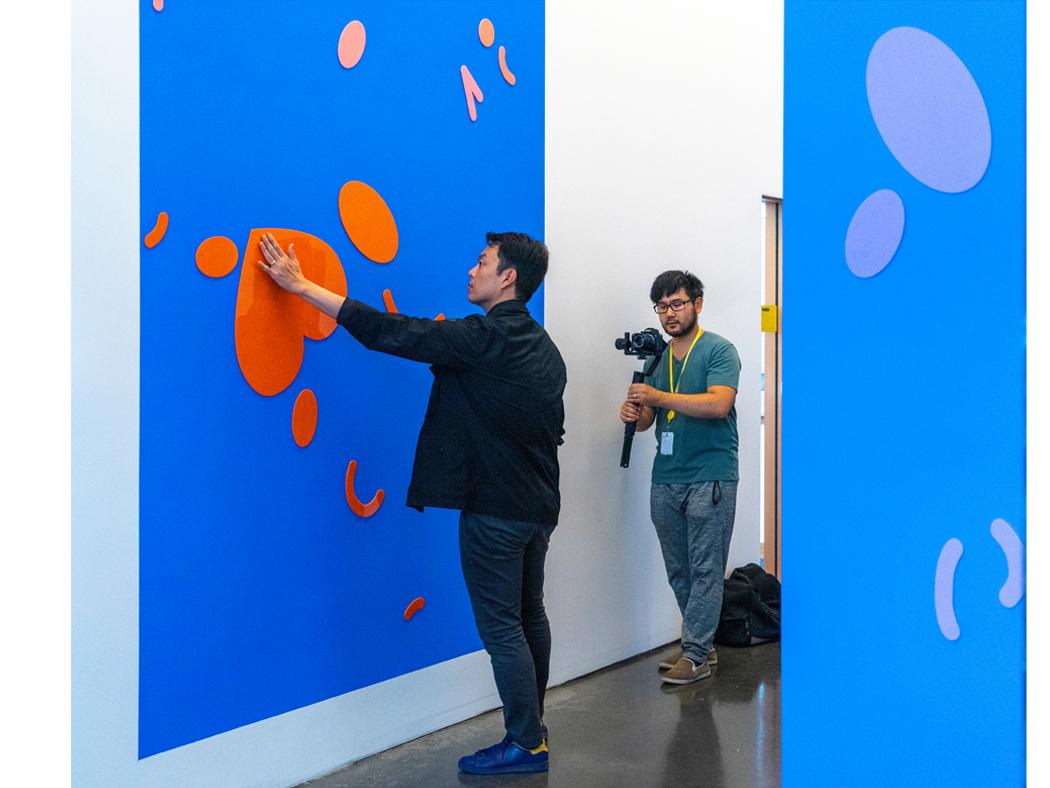 Kyuha Shim is shown interacting with an experiential design he installed.