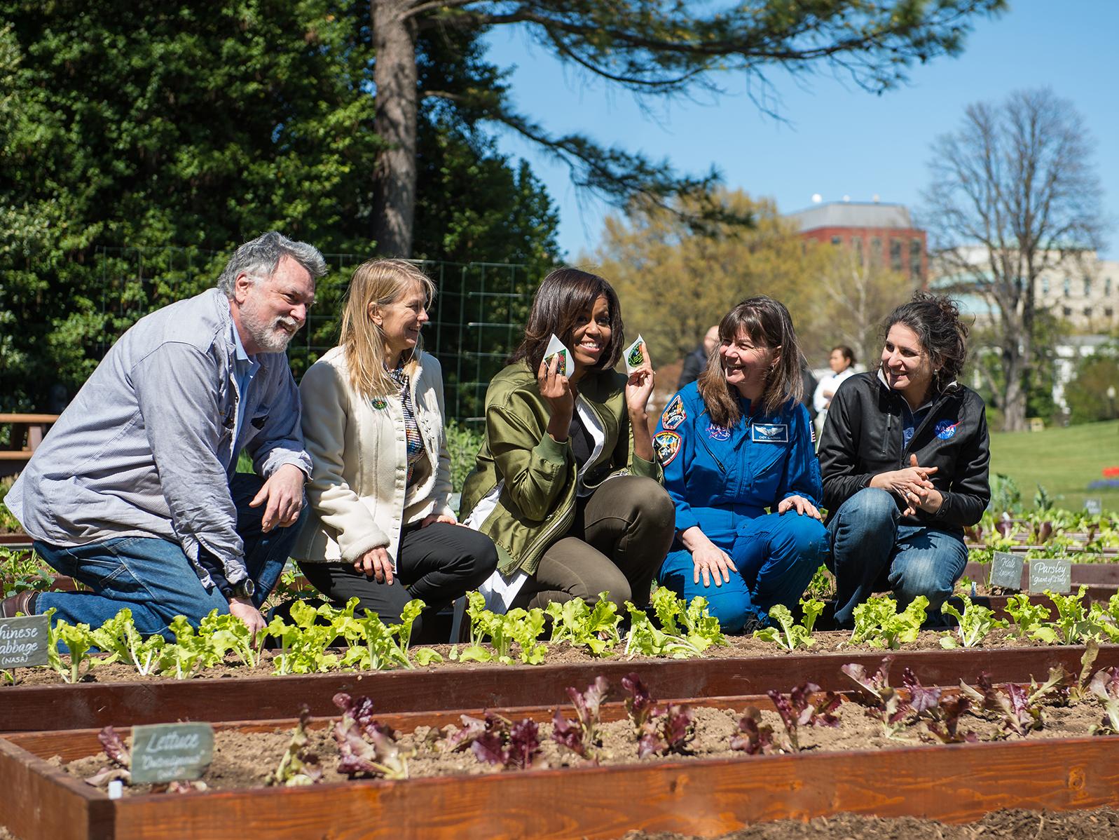 Dr. Gioia Massa is shown in a garden with colleagues and the then-First Lady Michelle Obama